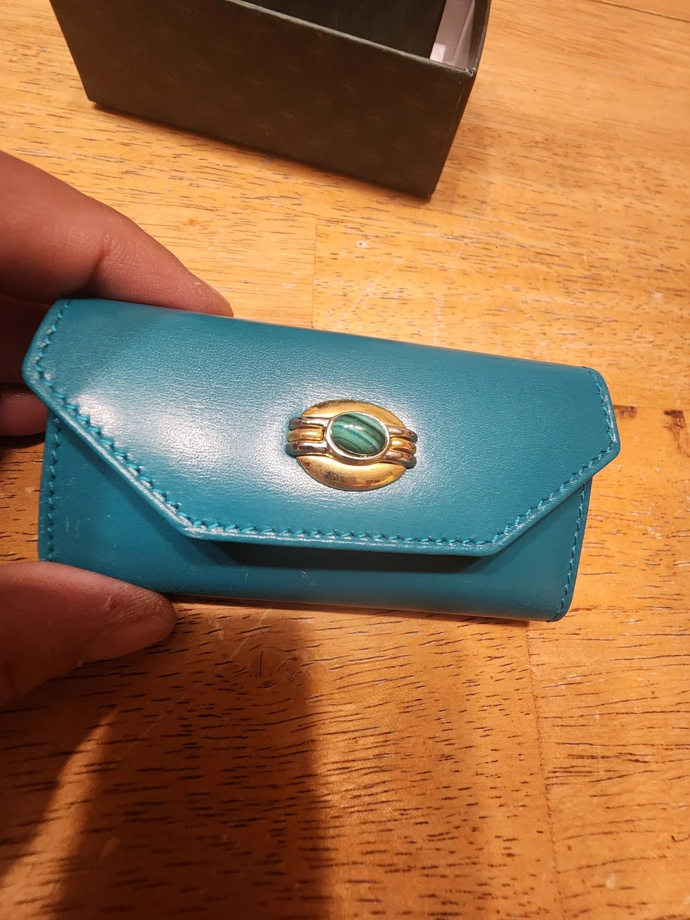 vintage Gucci teal leather key case featuring a distinctive cabochon stone